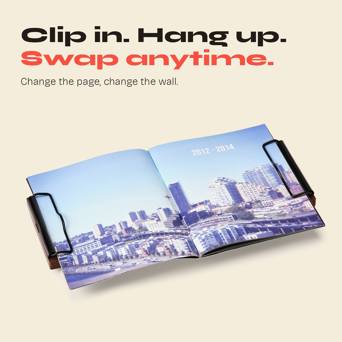 Open city photo zine held by black FORMA clips